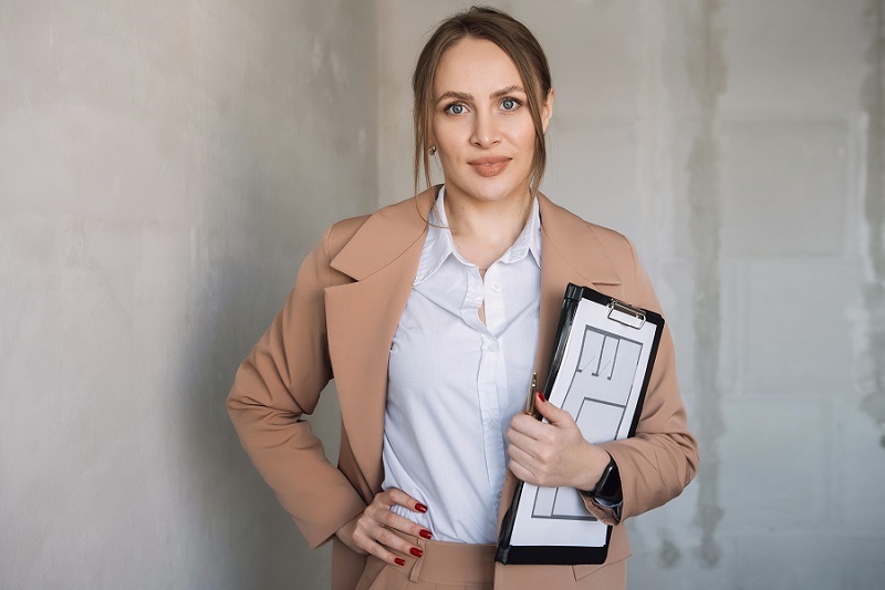 woman realtor in suit in unfinished building